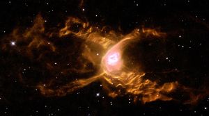 Two-lobed orange nebula with red-and-center and a black background scattered with stars.